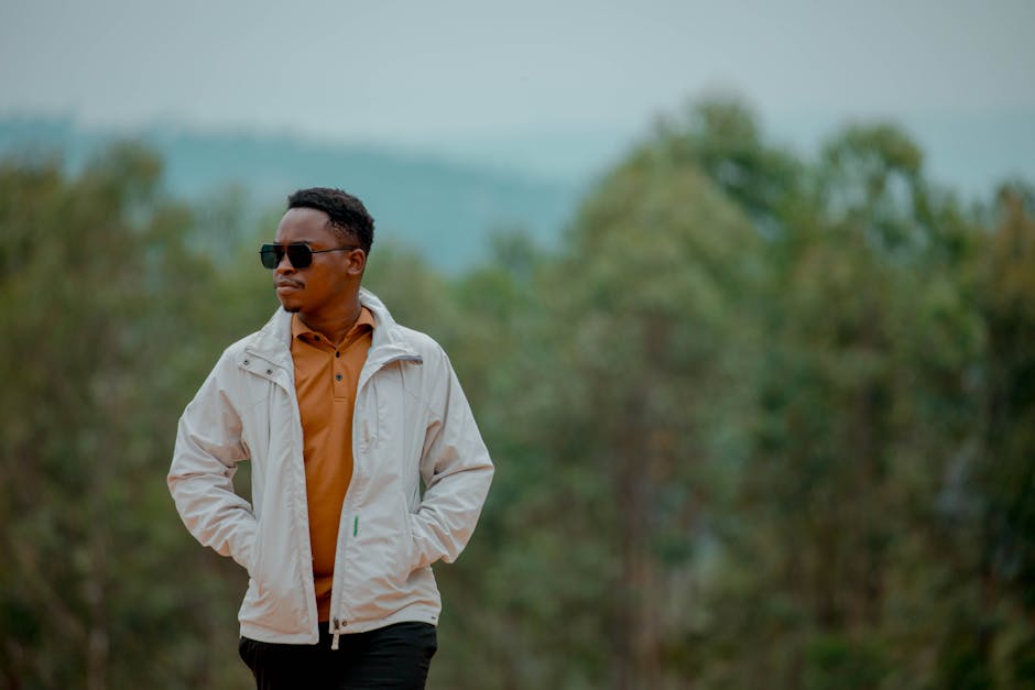 A stylish person with sunglasses enjoying a serene moment outdoors in Homa Bay, Kenya.
