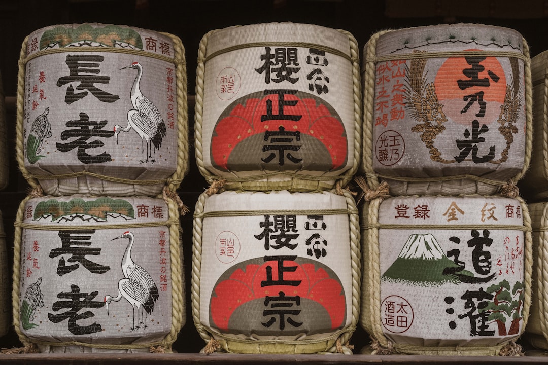 Japanese sake barrels are stacked together.