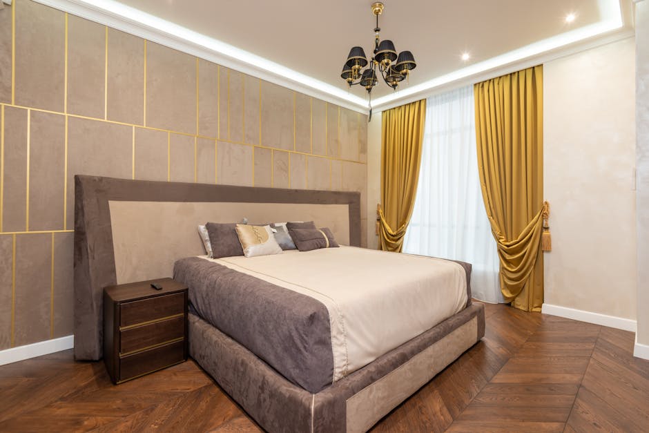 Stylish bedroom showcasing a plush bed, elegant chandelier, and opulent decor for a sophisticated ambiance.