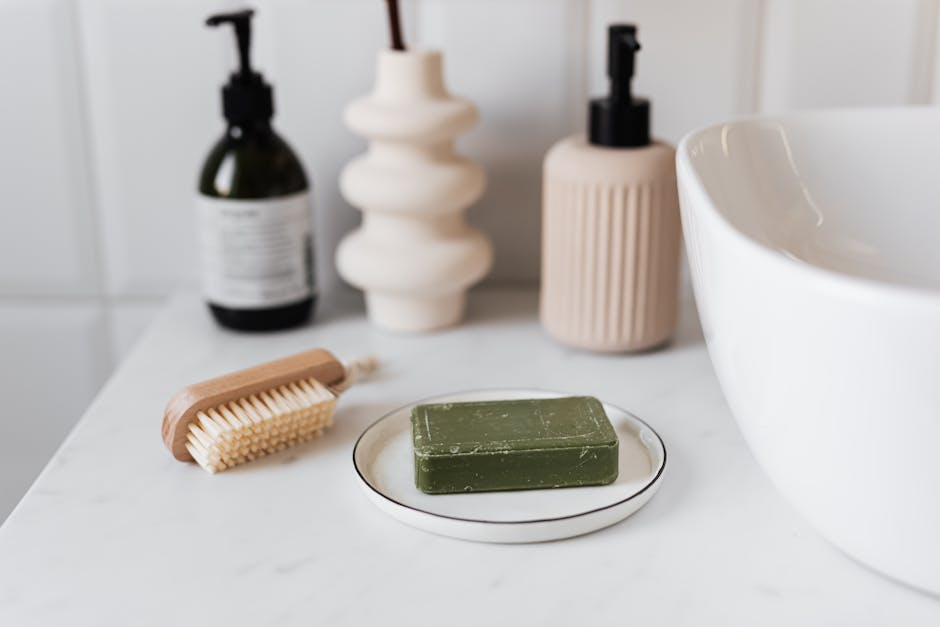 Close-up of green soap bar with stylish bathroom accessories in a minimalist setup.