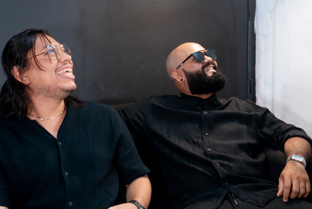 Two men laughing on a couch