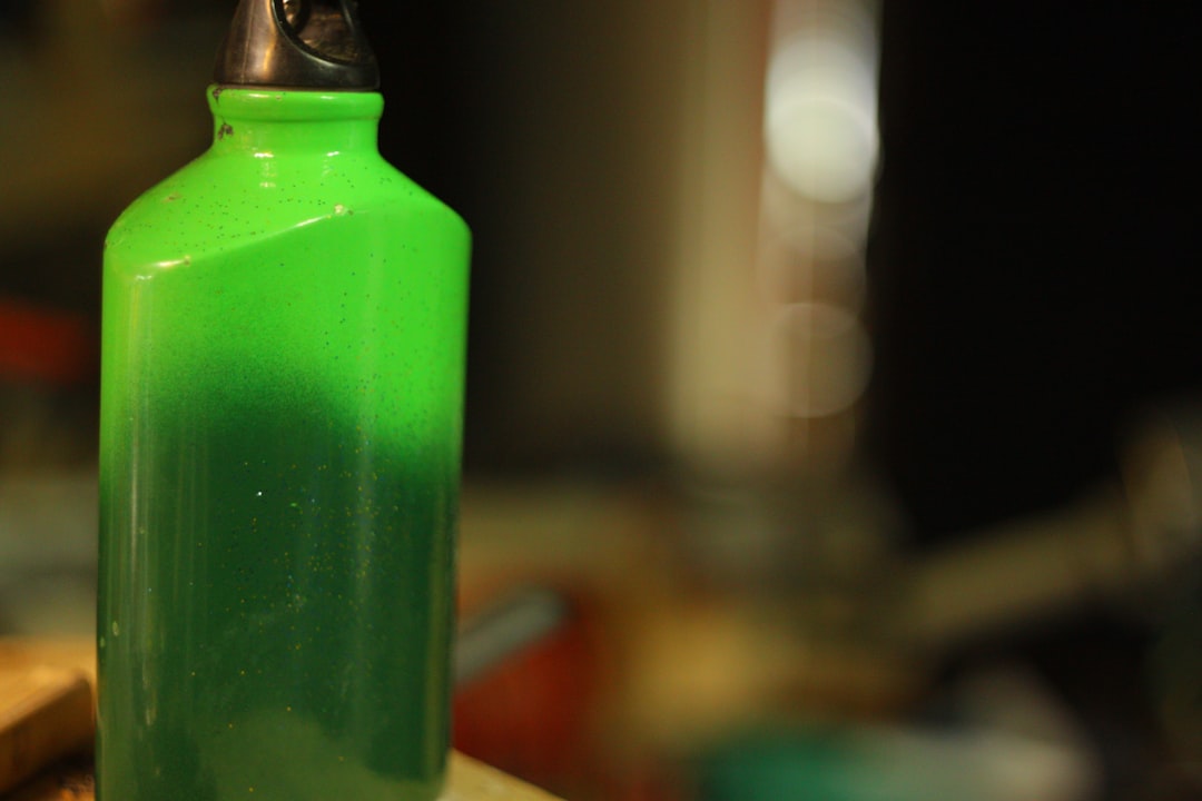 Green bottle with dark liquid inside