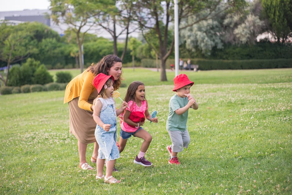 A joyful moment of a mother with children playing in a park in Portugal.