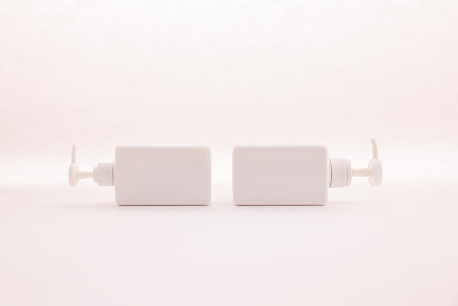 Simple and elegant white pump bottles on a clean white background, perfect for beauty product mockups.