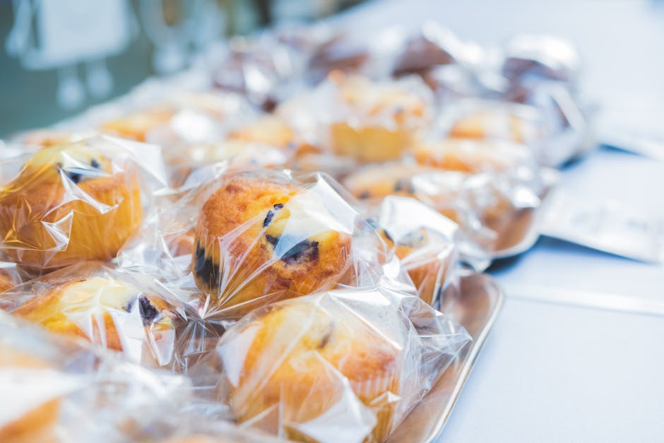 Close-up of blueberry muffins neatly wrapped in plastic in a Tokyo bakery, showcasing delicious pastries.